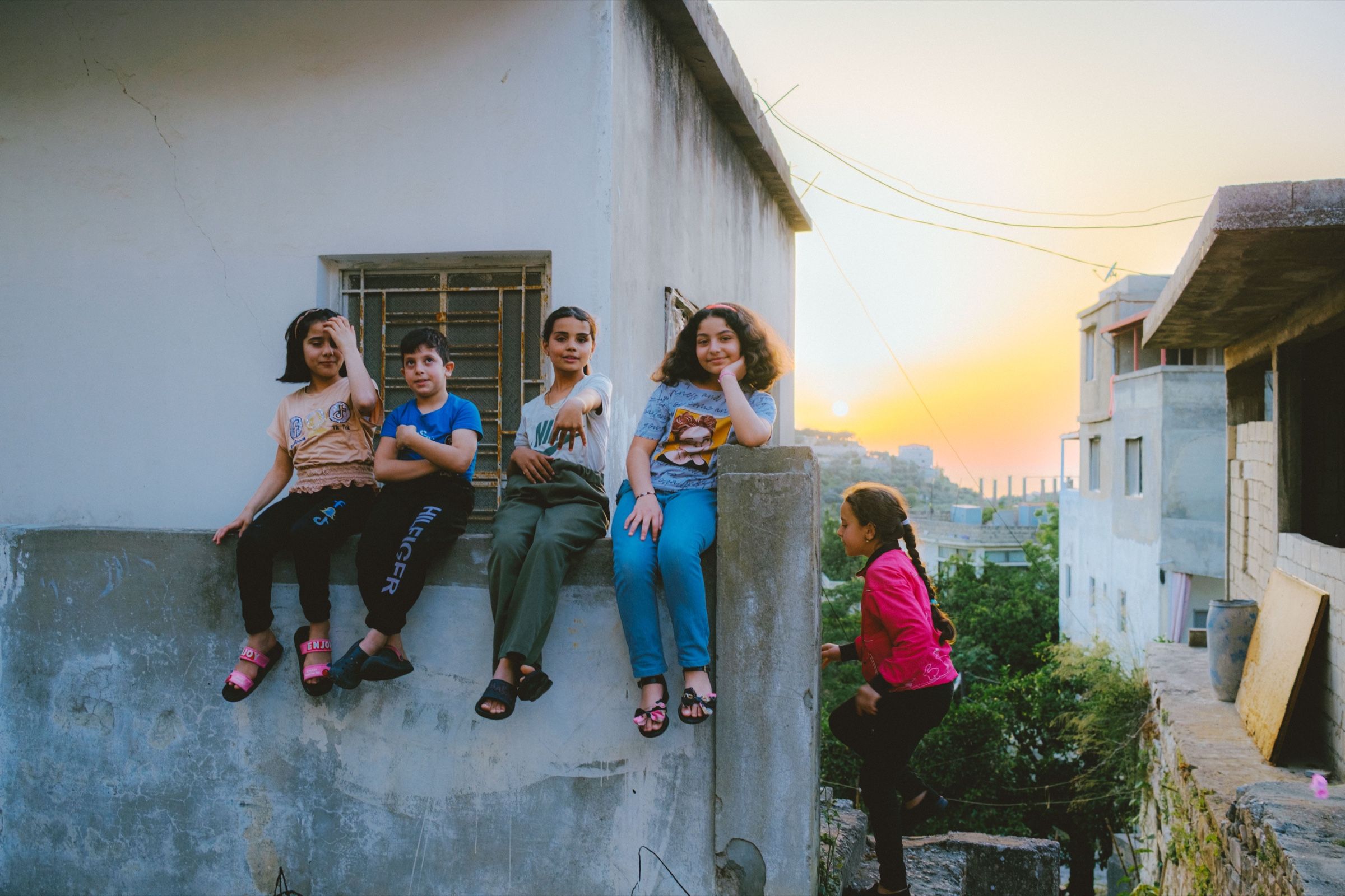 A candid photo of friends at sunset in one of Joun's neighbourhoods, 2024.