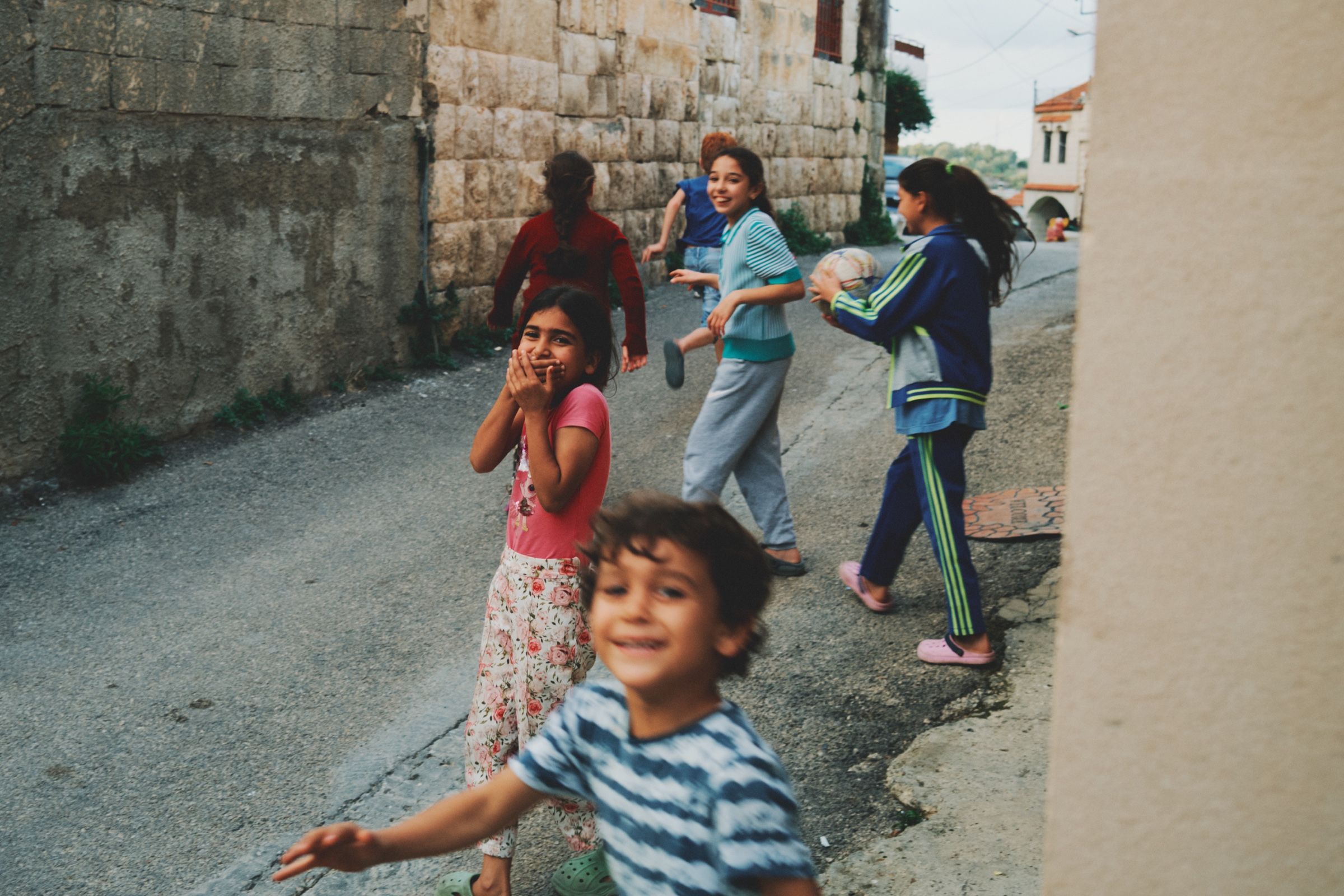 Kids running and playing in one of Joun’s old neighborhoods. The town of Joun, Lebanon, 2023.